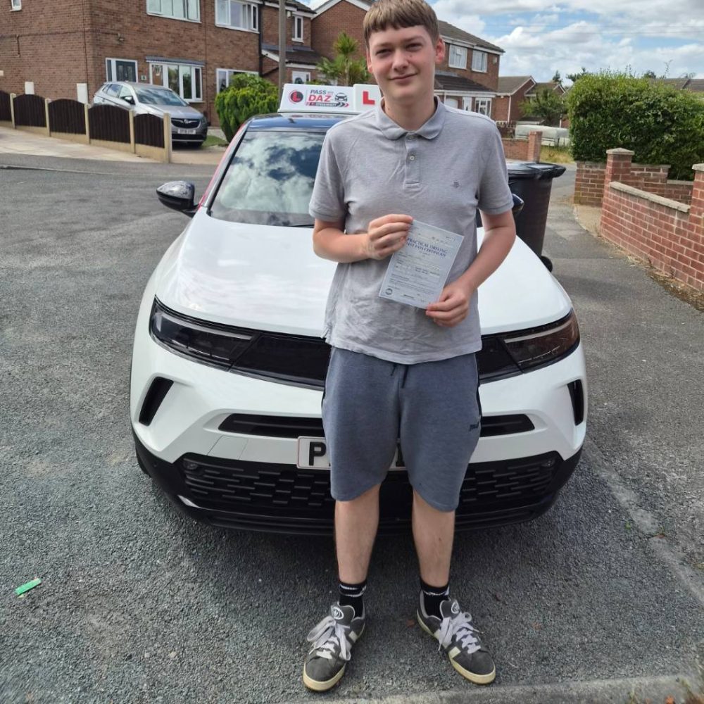 Learner driver holding his pass certificate after lessons with Pass with Daz